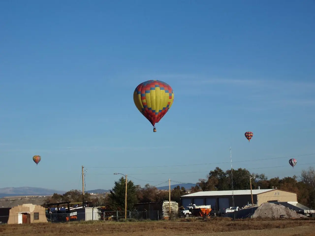 In this picture we can see there are hot air balloons. Under the hot air balloons, there are...