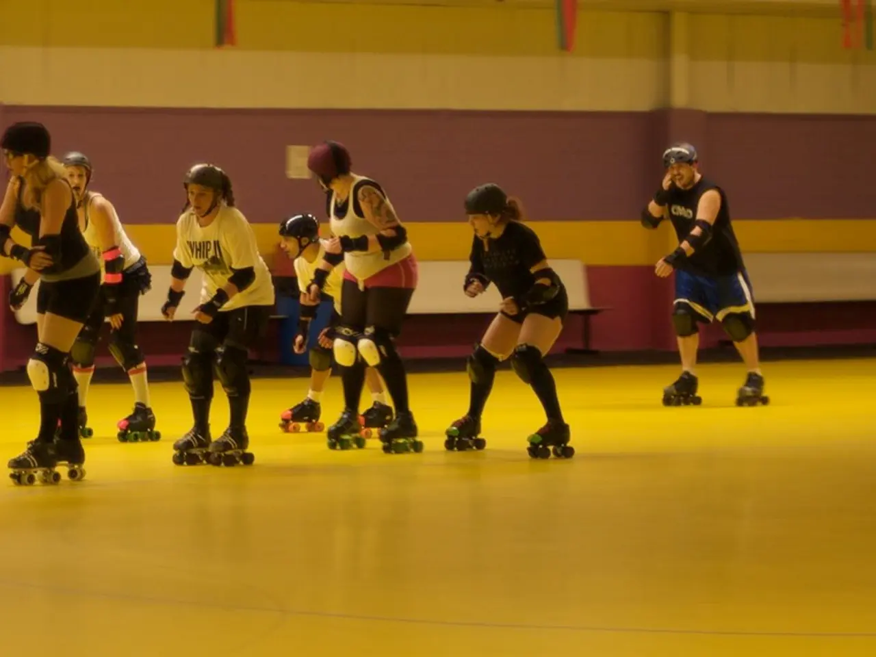 In this image, we can see persons wearing clothes and skating on the floor. There are benches in...