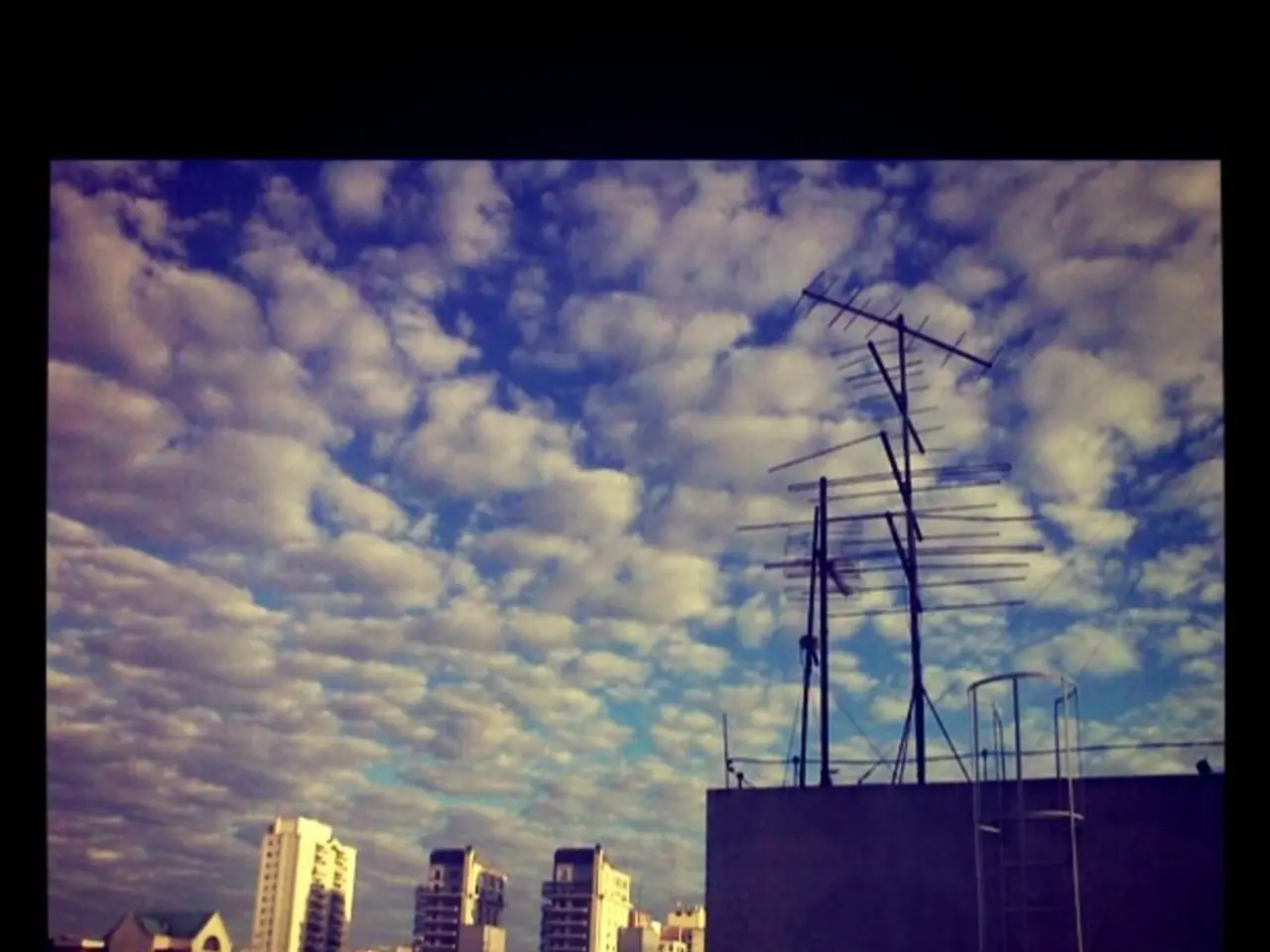 In this image I can see on the left side there are buildings, at the top it is the sky. On the...