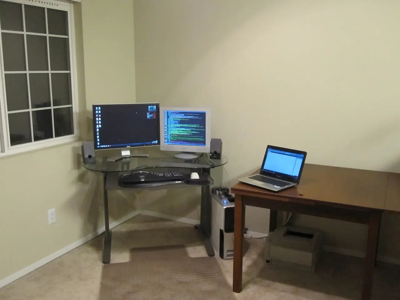 On this table there is a laptop. Under the table there is a printer. These are monitors, keyboard,...