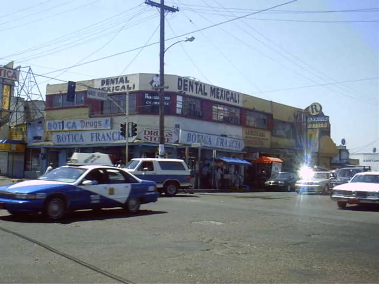 At the bottom of the image there is road. There are vehicles on the road. In the background of the...