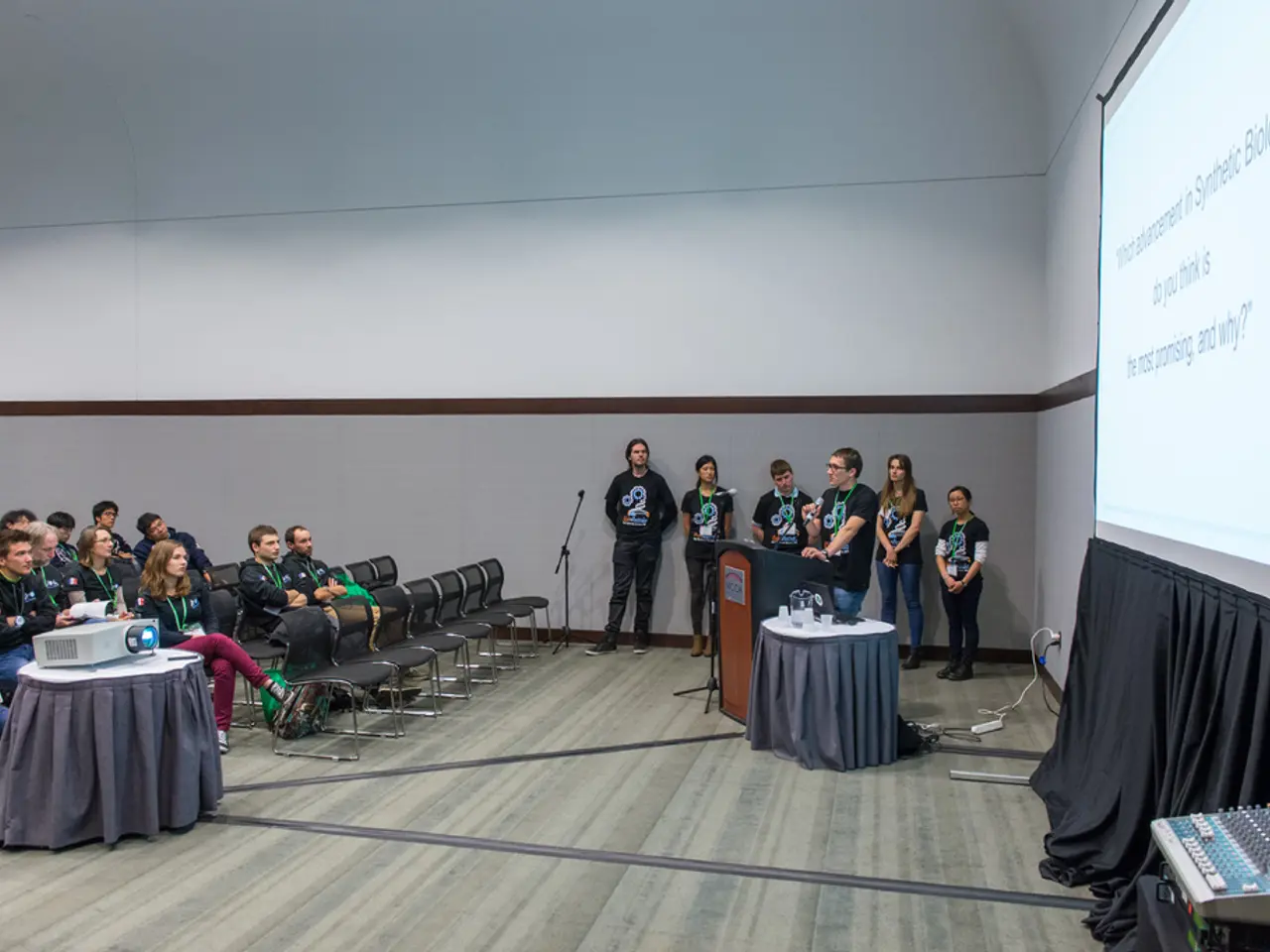 In this picture people are here for some meeting. In this we can see a person holding microphone...