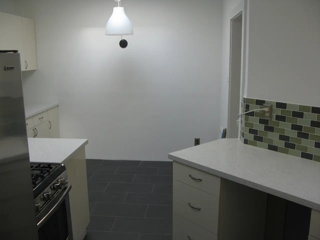 This picture describes about inside view of a room, in this we can find few cupboards, oven, gas...