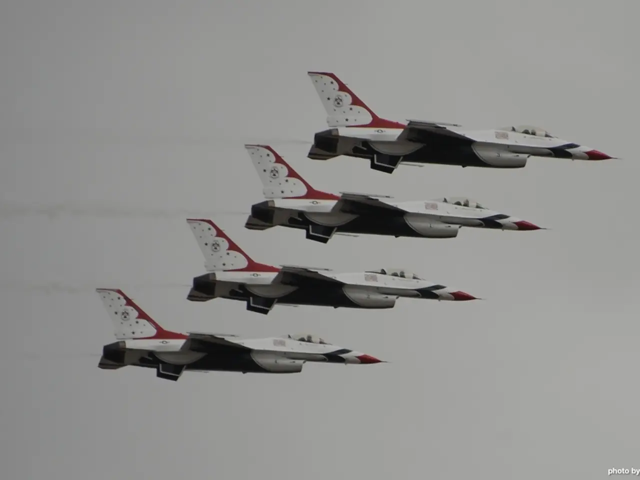 In this image, there are four jet planes flying in the sky. At the bottom right corner of the...