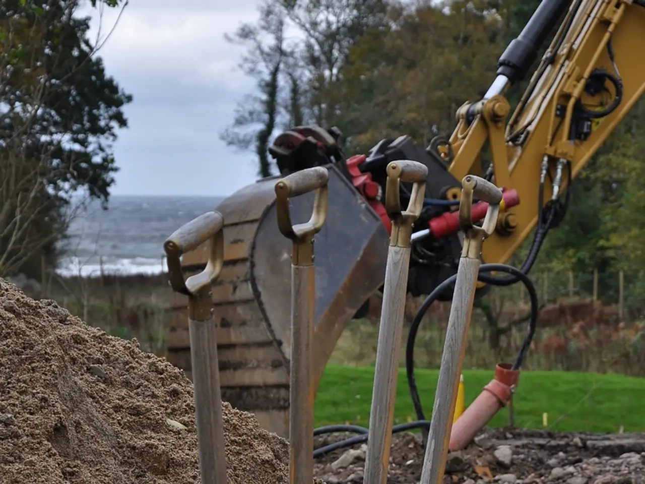 In this image there is an object placed on the sand, behind that there is a JCP. In the background...