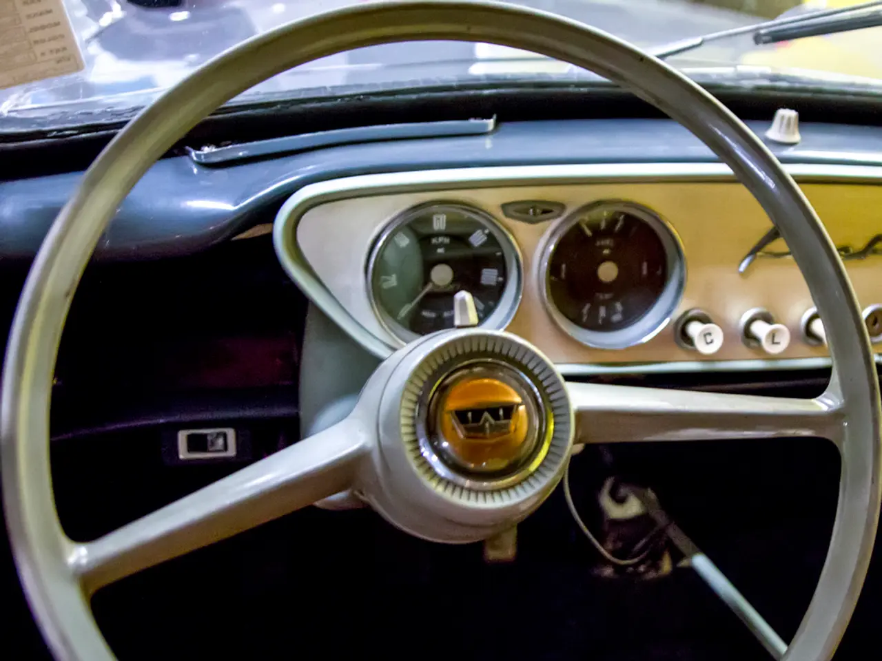 In this image I can see steering of a vehicle. I can also see speedometer and few other things.