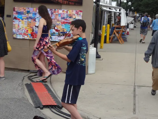 In the image we can see there are many people walking on the street, some of them are standing....