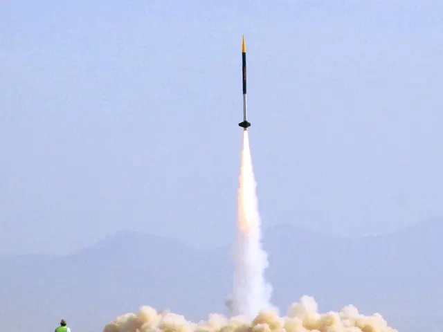 In this image there is a rocket moving into the air. Below to it there is the fire. There is smoke...