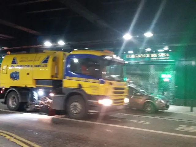 In this picture I can see the vehicles on the road. I can see light arrangements on the roof. I can...