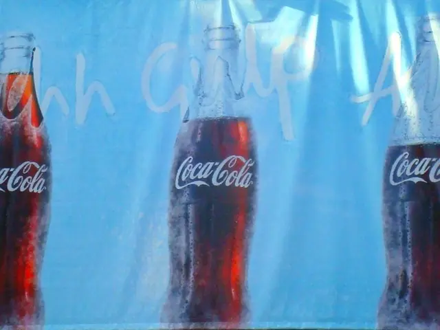 There are three coca cola bottles printed on a cloth.