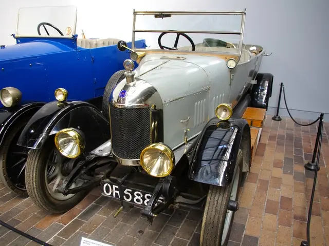 In the image we can see some vehicles. Behind the vehicles there's a wall. Bottom right side of the...