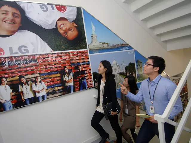 In this picture we can see people and they are wearing id cards and in the background we can see...