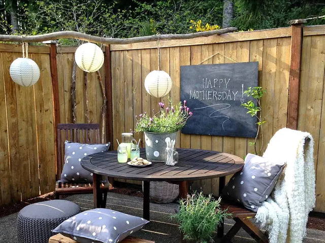 in this picture we can see a balcony which is decorated with table,cushions,lights,here we can also...