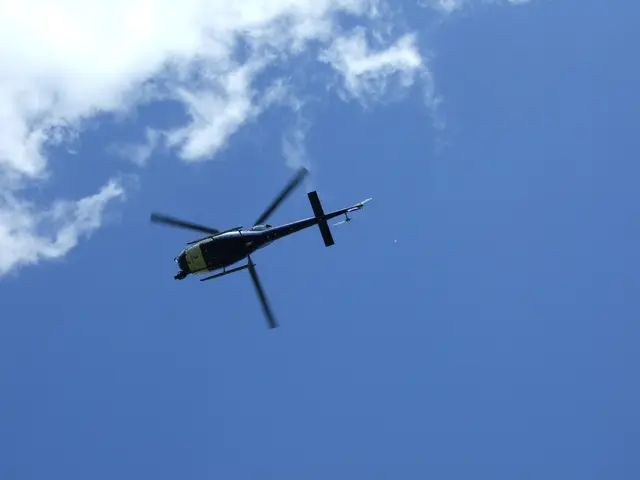In this image I can see there is the helicopter in blue color sky.