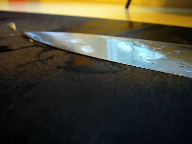 In this image there is a table, on that table there is a knife.