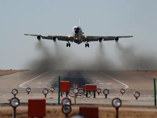In the image there is an airplane going on runway with a person running in front of it and in the...