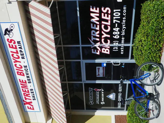 This image consists of a shop. In the front, there is a door made up of glass. To the left, there...