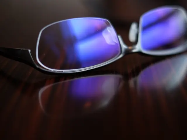 In this image we can see the spectacles on an object, which looks like a table.