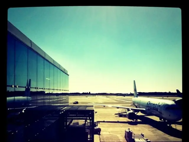 It is an edited image, there is a plane on the land and there is a truck beside the plane and on...